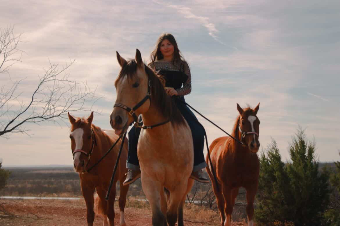Multi-generational ranch family at Texas cattle pen, golden hour