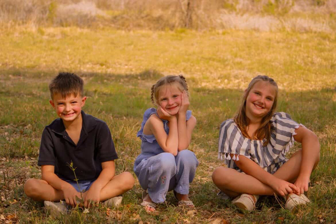Family in coordinated country outfits at golden hour ranch