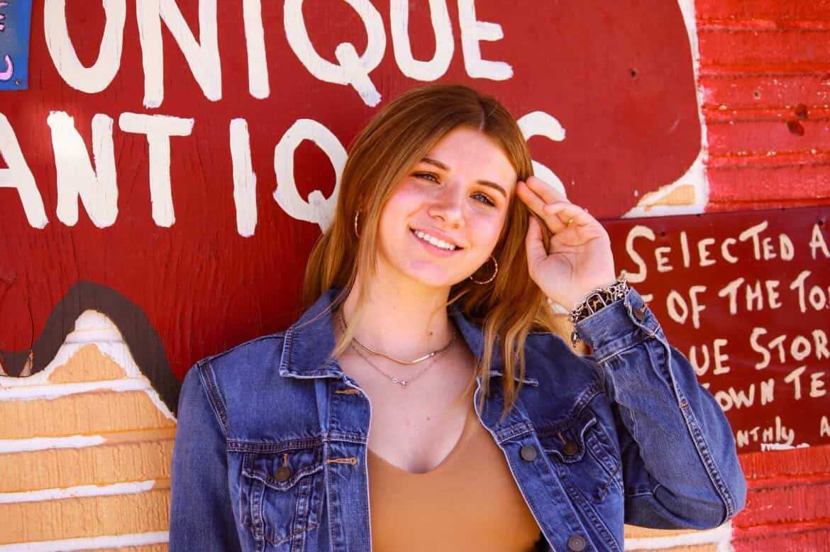 Senior girl on vintage truck at golden hour, Texas field